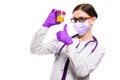 Young beautiful female doctor holding urine sample in her hands in medical mask and sterile gloves showing ok sign with Royalty Free Stock Photo