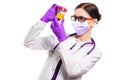 Young beautiful female doctor holding urine sample in her hands in medical mask and sterile gloves on white background Royalty Free Stock Photo