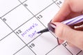 Girl hands with purple felt pen writing in calendar words Mothers Day Royalty Free Stock Photo