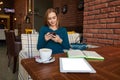 Young beautiful female holding mobile phone Royalty Free Stock Photo