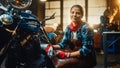 Young Beautiful Female Mechanic is Working on a Custom Bobber Motorcycle. Talented Girl Wearing a Royalty Free Stock Photo