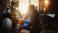 Young Beautiful Female Mechanic is Working on a Custom Bobber Motorcycle. Talented Girl Wearing a Royalty Free Stock Photo