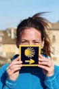 Young beautiful female pilgrim's portrait posing with the typical Camino de Santiago blue tile Royalty Free Stock Photo