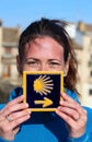 Young beautiful female pilgrim's portrait posing with the typical Camino de Santiago blue tile Royalty Free Stock Photo