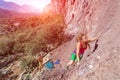 Young beautiful Female Rock Climber ascending rocky Wall Royalty Free Stock Photo