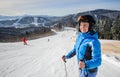 Young beautiful female skier on the middle of ski slope Royalty Free Stock Photo