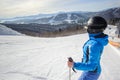 Young beautiful female skier on the middle of ski slope Royalty Free Stock Photo