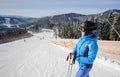 Young beautiful female skier on the middle of ski slope Royalty Free Stock Photo