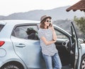 Young beautiful female travel girl in hat and sunglasses speaks