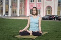 Young beautiful fit woman doeing yoga asans on the green grass with yoga mat Royalty Free Stock Photo