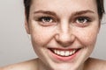 Young beautiful freckles woman face portrait with healthy skin