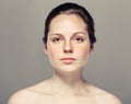 Young beautiful freckles woman face portrait with healthy skin