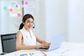 Young beautiful friendly operator woman with headset working in a call center. customer service pay attention and talking to Royalty Free Stock Photo