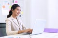 Young beautiful friendly operator woman with headset working in a call center. customer service pay attention and talking to Royalty Free Stock Photo