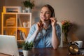 Young beautiful friendly smiling operator girl agent with headsets working in the office. Comfortable workplace Royalty Free Stock Photo