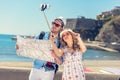 Young beautiful friends tourist couple and taking selfie stick picture together in town happy on sunny day