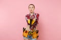 Young beautiful fun handyman woman in plaid shirt, denim shorts, kit tools belt full of variety instruments holding Royalty Free Stock Photo