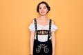 Young beautiful german woman with blue eyes wearing traditional octoberfest dress looking away to side with smile on face, natural Royalty Free Stock Photo