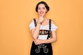 Young beautiful german woman with blue eyes wearing traditional octoberfest dress looking confident at the camera smiling with Royalty Free Stock Photo