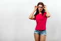 A young, beautiful girl adjusts her glasses. Isolated on a light background. Different human emotions, feelings of facial Royalty Free Stock Photo