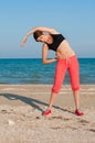 Young beautiful girl athlete playing sports on the beach Royalty Free Stock Photo