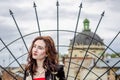 Young beautiful girl on a background of a fence and a dome of a temple during walk small streets of an old city of Lviv Royalty Free Stock Photo