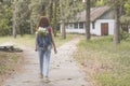 Young beautiful girl with backpack lost at the territory of abandoned summer kids camp