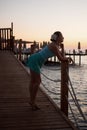 Young beautiful girl on the beach looking out to sea Royalty Free Stock Photo