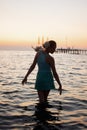 Young beautiful girl on the beach looking out to sea Royalty Free Stock Photo