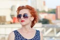 Young beautiful girl with beautiful appearance. Red-haired woman with a pretty face at sunset. A charming, smiling woman portrait Royalty Free Stock Photo