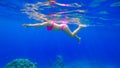 Young beautiful girl with a beautiful figure swims in the red sea is engaged in snorkeling Royalty Free Stock Photo