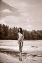 Young beautiful girl in bikini posing at the beach. Sepia