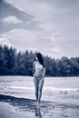 Young beautiful girl in bikini posing at the beach. Sepia
