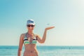 Young beautiful girl in bikini, sunglasses and cap on beach in Larnaca posing Royalty Free Stock Photo