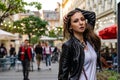 Young beautiful girl in black leather jacket on the street of city. Street fashion photo shoot with beautiful female model Royalty Free Stock Photo