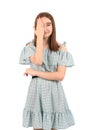 Young beautiful girl in a blue dress with polka dots on a white background Royalty Free Stock Photo