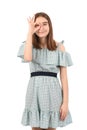 Young beautiful girl in a blue dress with polka dots on a white background Royalty Free Stock Photo