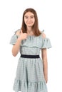 Young beautiful girl in a blue dress with polka dots on a white background Royalty Free Stock Photo