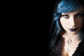 Young beautiful girl blue hair and make-up. Free left space black background Royalty Free Stock Photo