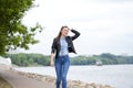 Young beautiful girl in blue jeans and a blue shirt on the background of spring street Royalty Free Stock Photo