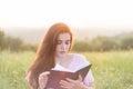 Young beautiful girl with book in the nature Royalty Free Stock Photo