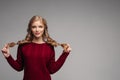 Young beautiful girl in bordo clothes posing at camera.