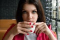 Young beautiful girl, businesswoman drinking tea or coffee sitting in cafe. Business lunch, break Royalty Free Stock Photo