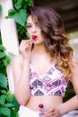 A young beautiful girl with a cherry in her hands in the summer Royalty Free Stock Photo