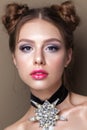 Young beautiful girl with the colorfull make-up, perfect skin, bunches hairstyle Royalty Free Stock Photo