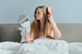 Young beautiful girl combing long hair with brush and mirror Royalty Free Stock Photo