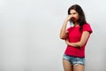 A young, beautiful girl covers her nose, a bad smell. Isolated on a light background. Different human emotions, feelings of facial Royalty Free Stock Photo