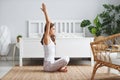 Young beautiful girl doing yoga in lotus position at home Royalty Free Stock Photo