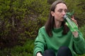 Young beautiful girl drinks vitamins, girl drinks water from a bottle in the park, morning run, daily vitamins, pills Royalty Free Stock Photo