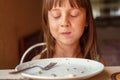 Young beautiful girl eating cheesecakes for breakfast with clothed eyes as symbol of delicious food Royalty Free Stock Photo